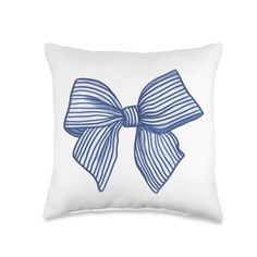 a white pillow with a blue bow on the front and back of it's side