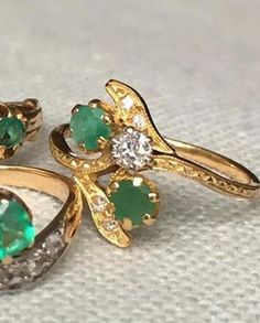 A lovely vintage leaf ring featuring two small diamonds on the leaves and a larger diamond in the mid, accompanied with two round cut natural emeralds. The details on the shank are amazing. Just a perfect ring for a romantic occasion, because the two cross set stones in this ring are symbolizing the connection between two lovers. The design is called: 'toi et moi' in France, meaning you and me. Provenance: made in France Metal: 18 carat yellow gold, hallmarked in the shank. Very good condition. Green Diamond Ring With Rose Cut Diamonds, Antique Green Emerald Ring With Prong Setting, Antique Green Jewelry With Single Cut Diamonds, Vintage Green Jewelry With Single Cut Diamonds, Vintage Green Emerald Ring With Brilliant Cut, Heirloom Three Stone Emerald Diamond Ring, Heirloom Three-stone Diamond Emerald Ring, Antique Green Diamond Ring With Rose Cut, Antique Green Diamond Ring With Rose Cut Diamonds