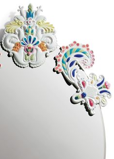 an ornately decorated mirror is shown against a white background with multi - colored accents