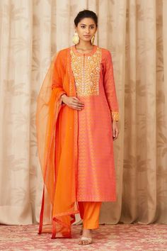 Orange kurta with all-over block print and zardozi embroidery around the neckline. Paired with straight pant and net dupatta.
Component: 3
Printed, Embroidered
Neckline: Round
Sleeve Length: Full
Fabric: Chanderi, Net
Color: Orange
Zardozi embroidery around the neckline and sleeves
Front concealed hook closure
Straight fit pant - Aza Fashions Chanderi Palazzo Set With Resham Embroidery For Diwali, Festive Chanderi Kurta With Zari Work, Designer Embroidered Banarasi Silk Palazzo Set, Traditional Chanderi Palazzo Set With Resham Embroidery, Embroidered Banarasi Silk Palazzo Set For Designer Wear, Chanderi Kurta With Resham Embroidery For Diwali, Embroidered Banarasi Silk Palazzo Set With Traditional Drape, Embroidered Banarasi Silk Palazzo Set, Diwali Straight Kurta Palazzo Set With Gota Work