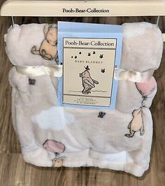 the pooh bear collection baby blanket is on display