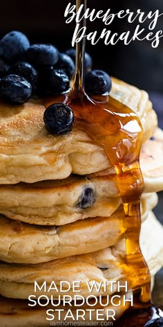 pancakes with blueberries and syrup are stacked on top of each other