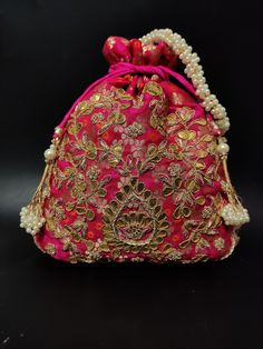 "traditional indian wedding delicate gota patti embroider gifting potli bag giveaways | rani pink drawstring purse with beaded chain Package Contents: 1 Size: 10\" x 8\" Designed with the heart, this beautiful Potli or batawa bag are eye catchy and made of premium material. Key Features: Embroidery art work. This potli is good match with both Indian and western outfits and are superb for wedding and festive parties. This would be best complement to your designer saree, lenhga or any other kind o Elegant Pink Potli Bag For Festivals, Festive Pink Embroidered Pouch, Festive Embroidered Pink Pouch, Traditional Pink Pouch For Festive Occasions, Traditional Pink Pouch For Festive Season, Diwali Wedding Bag With Mirror Work, Festive Pink Potli Bag For Party, Red Potli Bag With Zari Work For Diwali, Traditional Potli Bag With Mirror Work