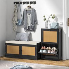 an entryway with shoes and coat rack