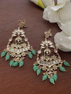 Gorgeous Earrings. Each piece is handcrafted . All the raw material used in this product is of high quality and is handcrafted with love. Height = 125 mm || Width = 65 mm Bollywood Look Indo Western Earring 100% Satisfaction Guarantee: Long Lasting Plating, High-Quality Stones. Gifting: This pair of earrings come in a beautiful gift pack , making it an ideal gift for birthday, wedding anniversary or wedding gift. Occasion: Perfect choice for any Indian occasion. Care: It is advisable that you ke Handmade Green Bridal Earrings For Celebration, Fusion Style Green Chandelier Earrings For Festive Occasions, Green Fusion Chandelier Earrings For Festive Occasions, Green Drop Earrings Danglers For Festivals, Festive Green Drop Earrings Danglers, Green Drop Earrings For Festivals, Fusion Style Green Chandelier Drop Earrings, Green Fusion Style Drop Chandelier Earrings, Handmade Green Chandbali Bridal Earrings