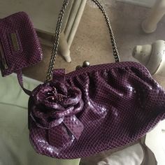 a purple purse sitting on top of a table