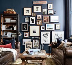 a living room filled with lots of furniture and pictures on the wall above it's coffee table