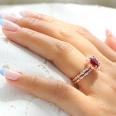 Simply stunning ruby and diamond bridal ring set showcases a large oval ruby engagement ring in the vintage floral diamond ring setting with a matching scalloped diamond wedding band as a perfect stackable ruby ring set! This oval ruby and diamond bridal ring can be made in white, yellow, rose gold, or platinum. ** The hand model's ring size is US ring size 6.25 Jewelry Information Engagement Ring: Center Stone:* Conflict Free Cultured Ruby (lab grown in the USA by Chatham®)* 9x7mm Oval Shaped B Oval Ruby Engagement Ring, Ruby Engagement Ring Vintage, Ruby Engagement Ring Set, Ruby Ring Set, Ruby Wedding Band, Ruby Wedding Rings, Halo Diamond Earrings, Diamond Bridal Ring Sets, Black Diamond Earrings