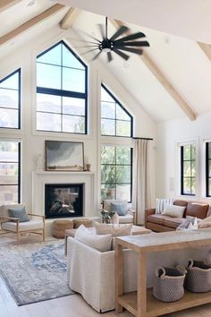 a living room filled with lots of furniture and a fire place in the middle of it