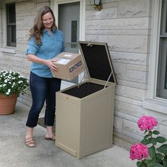 a woman standing next to a box that is open