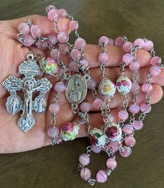 "This beautiful handmade rosary is made with 8mm cat's eye matte pink glass, 10mm ceramic beads and 2\"  crucifix.   Length: 27 inches long" Pink 8mm Beads Rosary Bracelet, Pink 8mm Bead Spiritual Rosary Bracelet, Pink Spiritual Rosary Bracelet With 8mm Beads, Pink Rosary With 8mm Round Beads, Pink Rosary With Miraculous Medal As A Gift, Handmade Pink Rosary With Round Beads, Handmade Pink Spiritual Rosary, Adjustable Pink Cross Rosary, Handmade Pink Rosary With Cross Shape