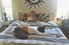 a woman laying on top of a bed in a bedroom