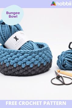 two balls of yarn are next to some scissors and a pair of eyeglasses