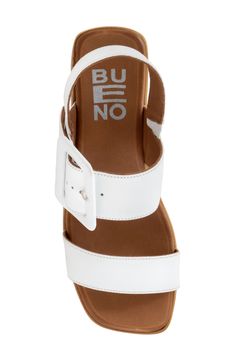 An oversized buckle accents the leather strap of an elegant square-toe sandal resting on a chunky wedge sole. 2 1/4" heel Cushioned footbed Leather upper and lining/rubber sole Made in Turkey Modern Wedge Sandals With Buckle Closure, Modern Wedge Sandals With Buckle Closure And Round Toe, White Leather Sandals With Rectangular Buckle, Wedge Sandals With Buckle Closure, White Leather Slingback Wedge Sandals, White Sandals With Buckle Closure And Square Toe, Block Heel Wedge Sandals With Buckle Closure, White Square Toe Sandals With Buckle Closure, White Platform Slingback Wedge Sandals