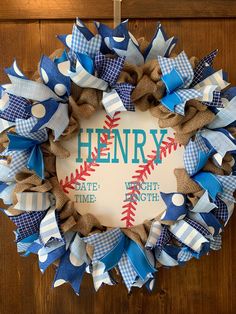 a baseball wreath with the words henry written in blue, white and red on it