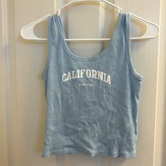 Very Good Condition. Never Worn. A Little Cropped Summer Light Blue Cotton Tank Top, Trendy Blue Tank Top For Spring, Trendy Blue Letter Print Tank Top, Trendy Blue Tops For Beach Season, Light Blue Casual Beach Tank Top, Trendy Light Blue Tank Top For Beach, Trendy Light Blue Tank Top For The Beach, Cute Blue Summer Tank Top, Cute Blue Tank Top For Beach