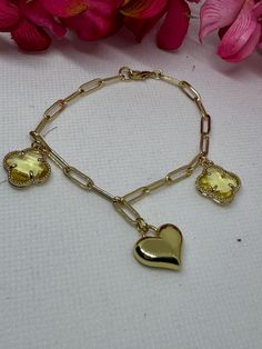 Yellow clovers & a gold heart charms were used in this  7 1/2 in bracelet. Gold Metal Charm Bracelet With Heart Beads, Elegant Gold Charm Bracelet With Heart Beads, Gold Bracelets With Heart Pendant Charms, Gold Plated Charm Bracelet For Valentine's Day, Heart-shaped Yellow Gold Chain Bracelet With Charms, Yellow Gold Heart Chain Bracelet With Charms, Yellow Gold Heart-shaped Chain Bracelet With Charms, Valentine's Day Gold-plated Charm Bracelet, Valentine's Day Gold Plated Charm Bracelet