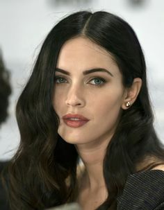 a woman with long black hair and blue eyes