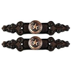 two brown and black metal handles with stars on them