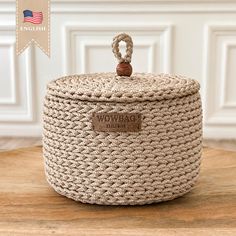 the woven storage basket is sitting on top of a wooden table with an american flag in the background