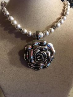 This necklace created by Jewelry By CARMAL is made of a silver plated flower pendant, mother of pearl gemstones, silver plated: daisy spacers, lobster claw clasp and findings. This necklace measures 20 inches in length and the pendant is 1 3/4 inches. View more beaded necklaces: http://www.etsy.com/shop/jewelrybycarmal?section_id=7999556 WE OFFER FREE STANDARD SHIPPING WITHIN THE UNITED STATES. All of our jewelry is unique and custom designed. We would love to assist you with any custom orders o Metal Flower Shaped Jewelry For Anniversary, Metal Jewelry With Flower Pendant For Wedding, Elegant Metal Flower Necklace For Wedding, Silver Flower Necklace For Wedding, Flower Shaped Costume Jewelry Necklace For Wedding, Flower Shaped Wedding Costume Jewelry Necklace, Elegant Metal Jewelry With Flower Charm, Elegant Beaded Flower-shaped Jewelry, Elegant Silver Flower Necklace With Decoration