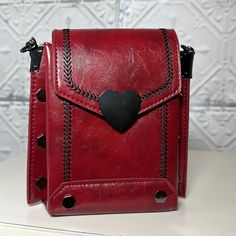 Beautiful Deep Burgundy Crossbody/Carry/Shoulder Bag Is Made From High Quality Pu Leather. The Gunmetal Chain Handle Has A 6”Drop And Is Not Removable. Also Comes With A Removable Navy Patterned Nylon Adjustable Strap With A 16”- 25” Drop. Accented With A Black Heart Magnetic Closure, Black Arrow Stitching And Gunmetal Grommets. Two Individual Large Pockets Inside To Hold All Your Items. 7.5” T X 7” W X 3”D. Burgundy Bag, Black Arrow, Deep Burgundy, Black Heart, Magnetic Closure, Inside Pocket, Pu Leather, 3 D, Magnets