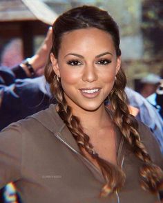 a woman with long braids smiling at the camera