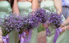 the bridesmaids are holding bouquets of lavender