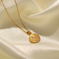 The Sun and Moon Necklace, in 18k gold plating, beautifully symbolizes celestial harmony. Its intertwined sun and moon design is perfect for those who love to wear pieces that reflect cosmic balance and elegance. Sun And Moon Design, Half Moon Necklace, Sun And Moon Necklace, Feminine Jewelry, Tarnished Jewelry, Moon Pendant Necklace, Medallion Necklace, Gold Piece, Royal Jewelry