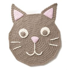 a crocheted cat head on top of a white wall