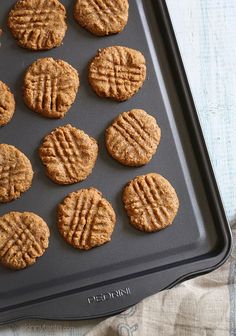 twelve peanut butter cookies on a baking sheet ready to go into the oven for baking