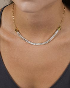 You'll love showing off this shining piece everywhere you go! This elegant necklace is lined with CZ stones and is adjustable for a perfect fit. Available in gold and silver tones. Materials: 14K gold or rhodium plated brass, cubic zirconia Features: Measures 16" with 2" extender, 6" CZ accent, 5.75x2.5mm CZ stones, Lead & Nickel free, lobster clasp Gold Tennis Necklace With Baguette Diamonds, Gold Baguette Diamond Tennis Necklace Gift, Cubic Zirconia Rhinestone Choker With Adjustable Chain, Cubic Zirconia Rhinestone Necklace For Anniversary, Anniversary Rhinestone Necklace With Adjustable Chain, Cubic Zirconia Tennis Necklace With Adjustable Chain As Gift, Gold Tennis Necklace With Adjustable Chain And Cubic Zirconia, Adjustable Cubic Zirconia Necklace With Sparkling Stones, Gold Cubic Zirconia Tennis Necklace For Party