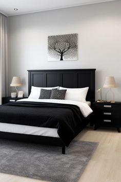 a black and white bedroom with a tree painting on the wall