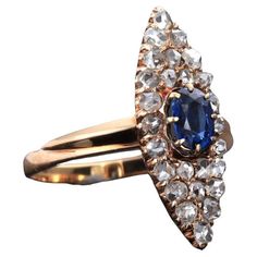 Ring made of 14 carat red gold with a marquise-shaped front decorated with a sapphire weighing approx. 0.30 ct. Additionally, it is surrounded by numerous diamonds in the old rosette cut. Color: G-H, purity: SI-P. Size: 13 (53) - size adjustment possible. Origin: Eastern Europe, circa 1900. Awning dimensions: 2.2 x 0.8 cm. Product weight: 3 g. The ring is in very good condition, shows signs of use due to age. Antique Gold Rings, Split Shank Ring, Vintage Cocktail Ring, Round Diamond Ring, Golden Ring, Sapphire Stone, Art Deco Ring, Antique Rings, Cocktail Rings