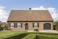 a house with hedges in front of it