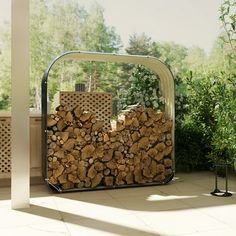 a large pile of wood sitting in the middle of a patio next to a potted plant