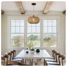 a dining room table with six chairs and a basket hanging from the ceiling