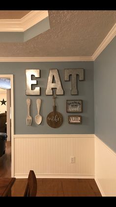 a dining room wall decorated with letters and utensils