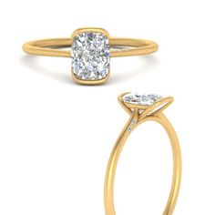 a yellow gold ring with an oval cut diamond in the center