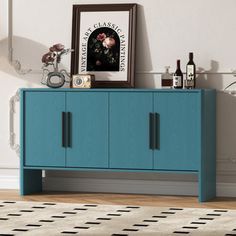 a blue cabinet sitting on top of a wooden floor next to a white rug and wall