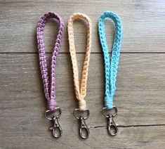 three different colored leashes with metal hooks