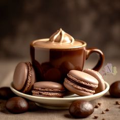 chocolate macaroons and a cup of coffee on a saucer with some nuts