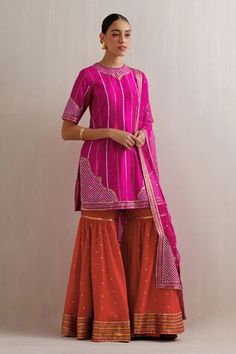 Magenta pink kurta with sequin, zari, aari embroidery in stripe pattern. Paired with red gharara and dupatta. - Aza Fashions Designer Pink Sharara With Dori Work, Diwali Pink Palazzo Set With Dori Work, Pink Sharara With Dupatta For Eid, Pink Palazzo Set With Dori Work For Navratri, Pink Sharara With Dori Work, Pink Sharara With Gota Work For Festive Occasions, Designer Pink Sharara With Dupatta, Pink Sharara With Dori Work For Navratri, Pink Palazzo Set With Gota Work For Festivals