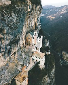 an aerial view of some buildings on the side of a cliff