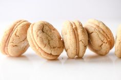 five cookies are lined up on a white surface