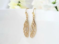 These lovely butterfly wings, will add a touch of beauty to your day! They have a high quality, 24k champagne gold plating. Tiny zircon gemstones also embellish the wings. They can be dressed up or down, and will compliment a variety of attire. Product details: * 18k gold plated ear wires; Lead and nickel free * 24k champagne gold plated wings * Clear zircon gemstones - Length:   1.5 inches - Width:    .3 inches ❤ Click the link, to see more unique jewelry from Flutterbird: https://www.etsy.com/shop/FlutterbirdCo My goal is to provide every customer with exceptional service. Please message me if you have any questions. Thank you for supporting my small business!  Please visit my F.A.Q. and shop policy sections for additional info. Jewelry For Champagne Dress, Elegant Butterfly Filigree Jewelry, Elegant Butterfly Shaped Filigree Jewelry, Elegant Gold Butterfly Earrings, Elegant Gold Butterfly-shaped Earrings, Gold Butterfly Earrings For Formal Occasions, Elegant Gold-plated Pierced Crystal Earrings, Butterfly Cubic Zirconia Wedding Earrings, Elegant Gold Plated Butterfly Jewelry