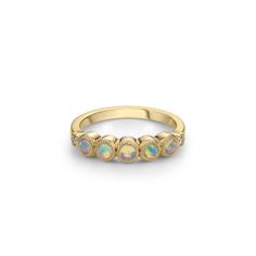 Our fan-favourite Laurette band ring has 5 hand beaded bezels set with gorgeous Australian opals, capped with diamonds at each end in our our trademark setting. Easy to wear and perfect to stack. Also available in Montana ombre sapphire, Montana pastel sapphire and purple sapphire ombre. 14K yellow gold 5 x round cabochon Australian opals (approx. 3mm) 2 x round diamonds 0.04cts Approx. 2.85mm rise off finger Band width approx. 1.85mm (approx. 4mm at bezels) In stock size 6.5 (complimentary sizi Finger Band, Rings Stacking, Opal Band, Purple Sapphire, Montana Sapphire, Zircon Ring, Blue Zircon, Sapphire Jewelry, Australian Opal