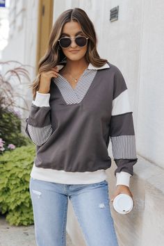 Elevate your casual wardrobe with our Charcoal Color Block French Terry Sweatshirt! *Pre Order - Expected Arrival Date: Week of August 26th Crafted from soft and cozy French Terry fabric, this long sleeve sweatshirt features a stylish color block design with a striped pattern. The collared v neckline adds a touch of sophistication to this must-have piece. Made with 80% cotton and 20% polyester for ultimate comfort and quality. Pair it with jeans and comfy sneakers for the perfect lived-in outfit! Casual Long Sleeve Sweater With Striped Sleeves, Casual Tops With Striped Cuffs For Fall, Fall Tops With Striped Cuffs And Relaxed Fit, Winter Long Sleeve Tops With Striped Collar, Cotton Sweatshirt With Striped Cuffs For Fall, Fall Cotton Sweatshirt With Striped Cuffs, Cotton Long Sleeve Sweater With Striped Cuffs, Striped Relaxed Fit Sweatshirt For Fall, Relaxed Fit Long Sleeve Tops With Striped Cuffs