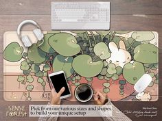 a person is holding a tablet while sitting in front of a mouse pad with plants on it