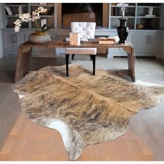 a cow hide rug in the middle of a living room